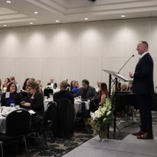 Superintendent Nosek standing at the mic on stage, speaking to the audience